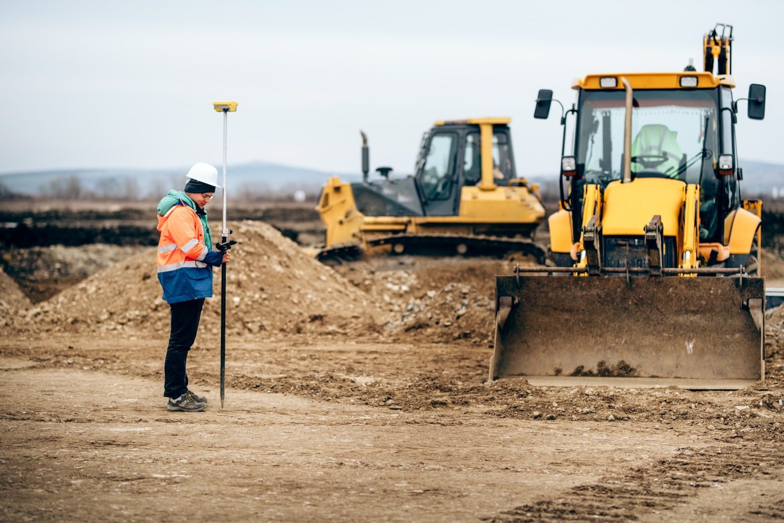 Bulldozer and backhoe loader on an earthworks site
